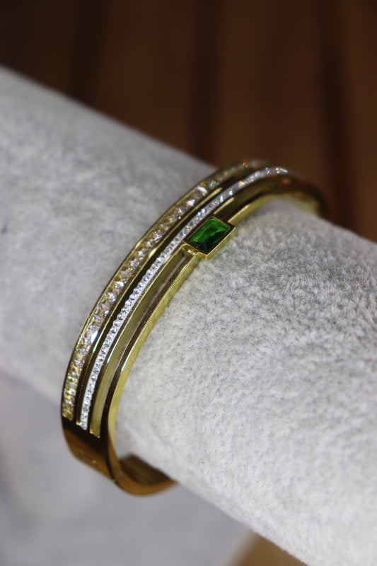 Gold bracelet with emerald stone.